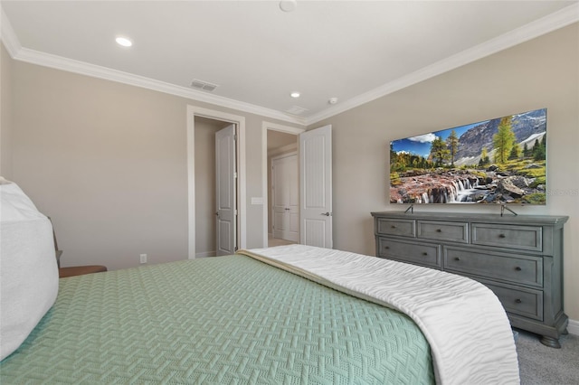 bedroom with ornamental molding and carpet flooring