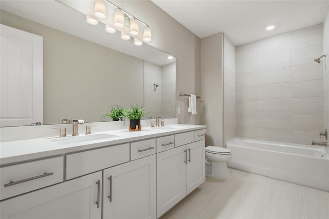 full bathroom featuring vanity, toilet, and tiled shower / bath combo