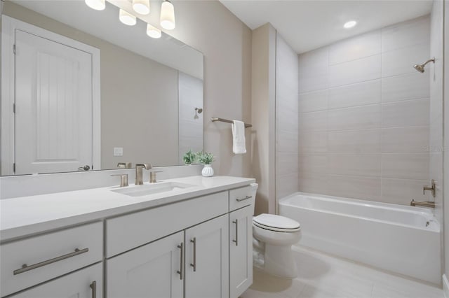 full bathroom featuring tiled shower / bath, vanity, toilet, and tile patterned floors