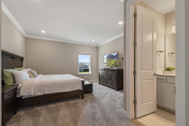 bedroom with light carpet, ornamental molding, and ensuite bath