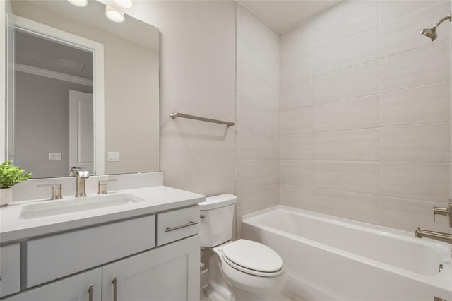 full bathroom with vanity, toilet, ornamental molding, and tiled shower / bath