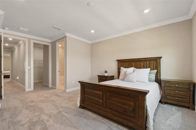 bedroom with light carpet, a closet, a spacious closet, and crown molding