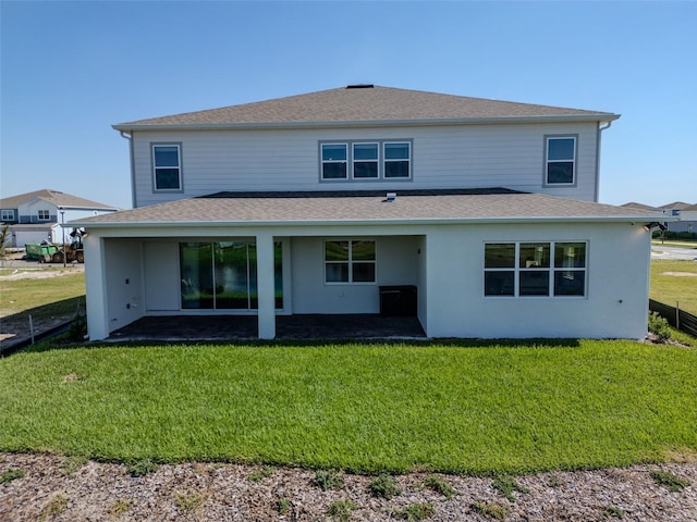 rear view of house featuring a yard and a patio area