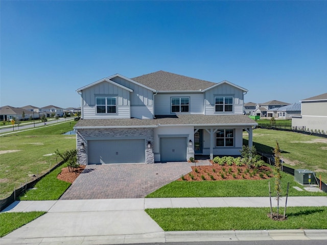 view of front of home with a front yard and a garage