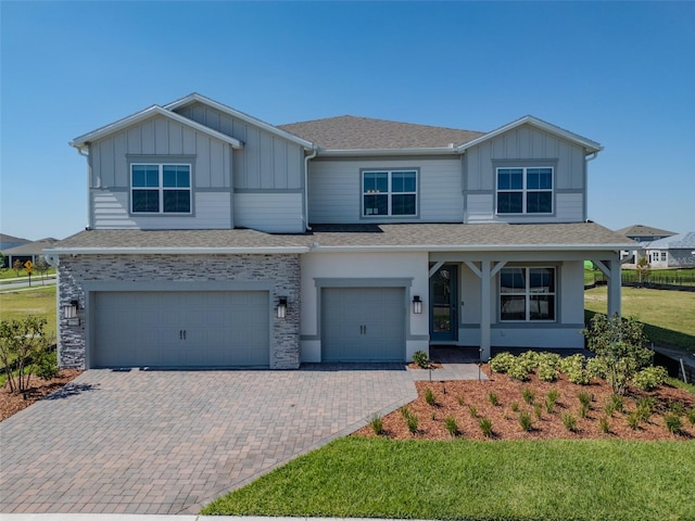 view of front of home featuring a garage and a front lawn