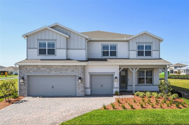 view of front of home with a front yard and a garage