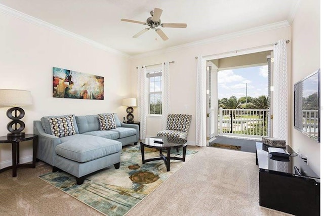 living room with ornamental molding, carpet flooring, and ceiling fan