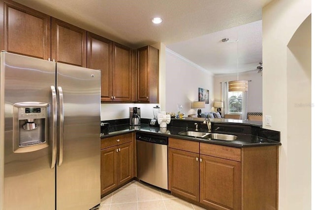 kitchen with stainless steel appliances, sink, crown molding, light tile patterned floors, and ceiling fan