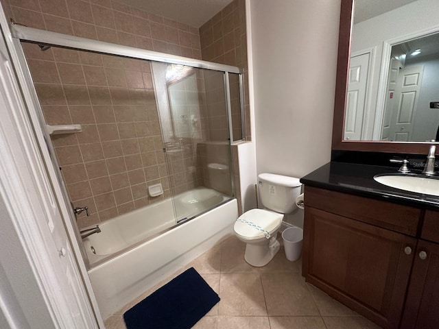 full bathroom with vanity, enclosed tub / shower combo, toilet, and tile patterned flooring