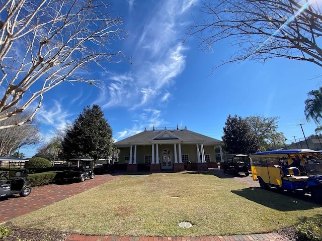 view of front of property with a front yard, a carport, and a porch