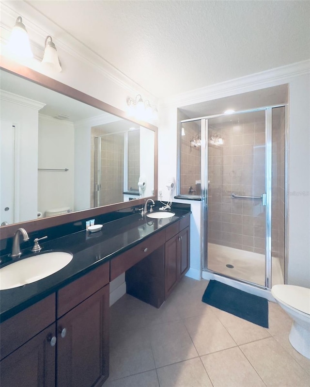 bathroom featuring toilet, ornamental molding, a shower with shower door, vanity, and tile patterned flooring