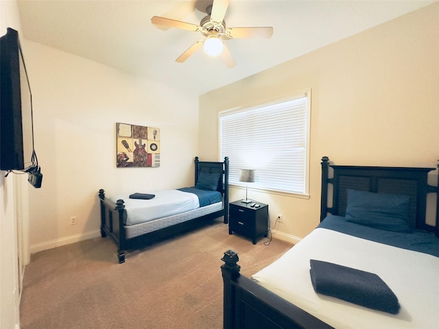 bedroom featuring light colored carpet and ceiling fan