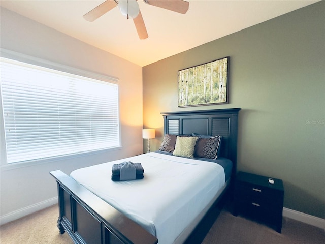 bedroom featuring ceiling fan, vaulted ceiling, and light colored carpet