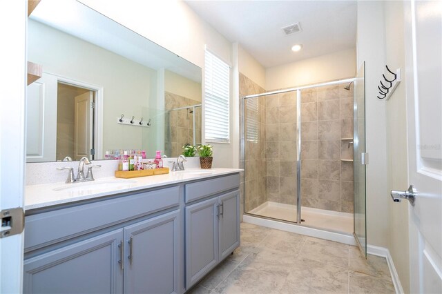 bathroom with walk in shower and vanity