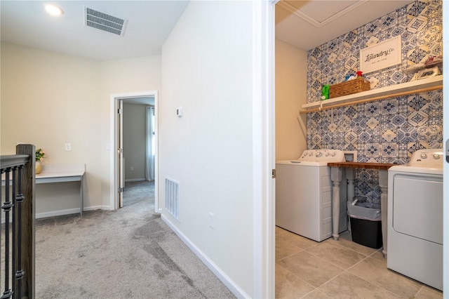 washroom featuring light carpet and washer and dryer