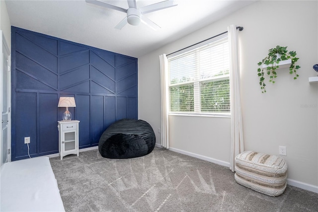 living area featuring ceiling fan and carpet floors