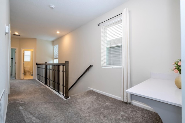 stairway featuring carpet and a wealth of natural light