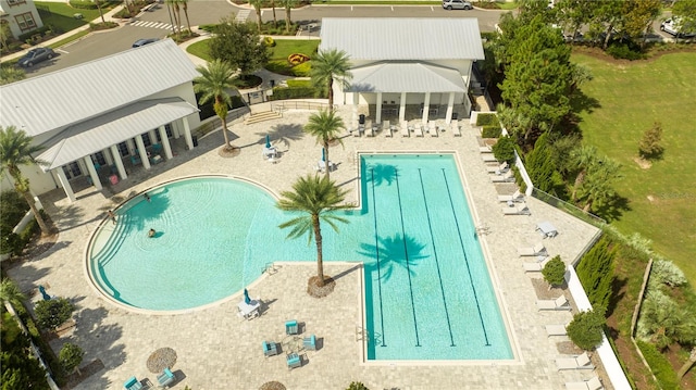 view of swimming pool featuring a yard and a patio area