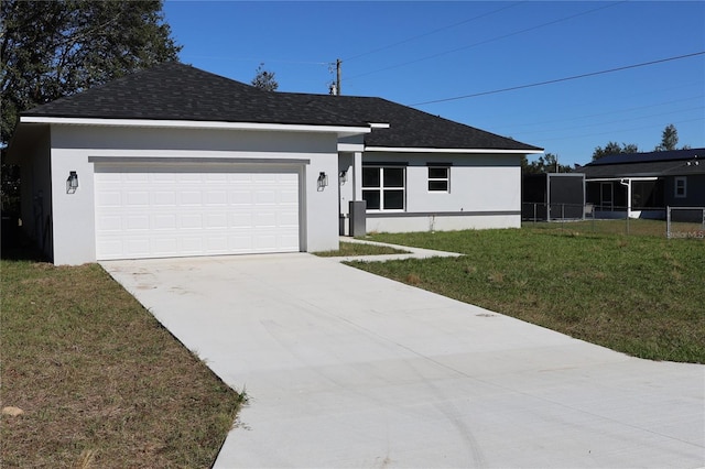 view of front of home with a front lawn and a garage