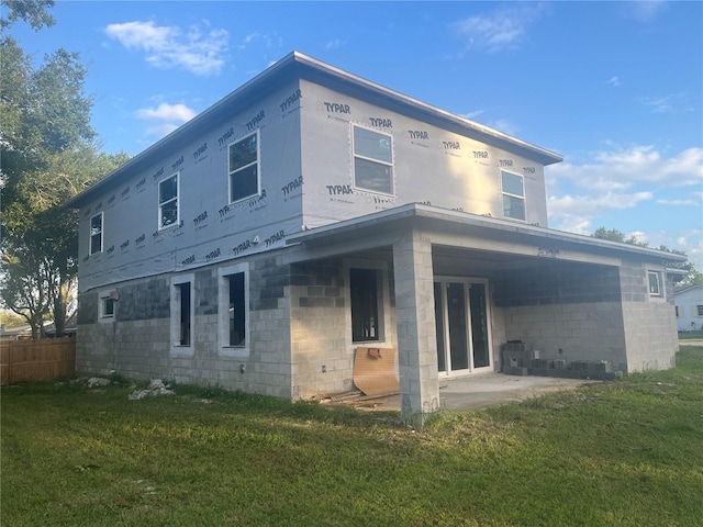 rear view of house with a yard and a patio area