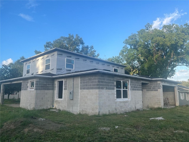 view of side of home featuring a yard