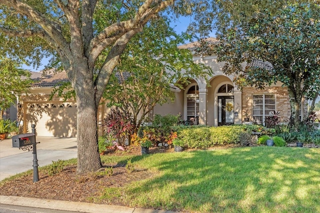 view of front of property with a front yard and a garage