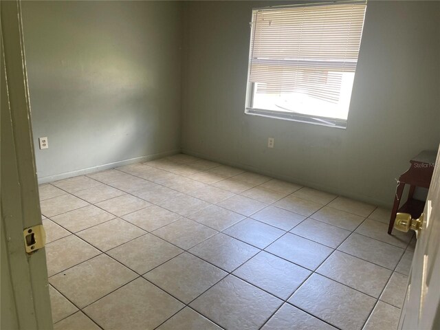 spare room featuring light tile patterned floors