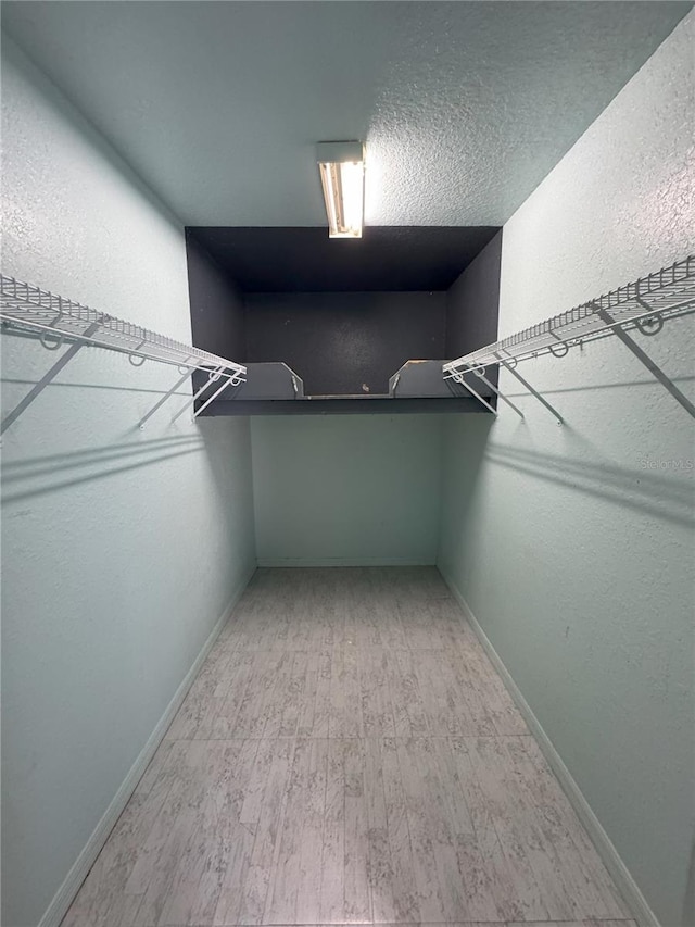 spacious closet featuring light wood-style flooring