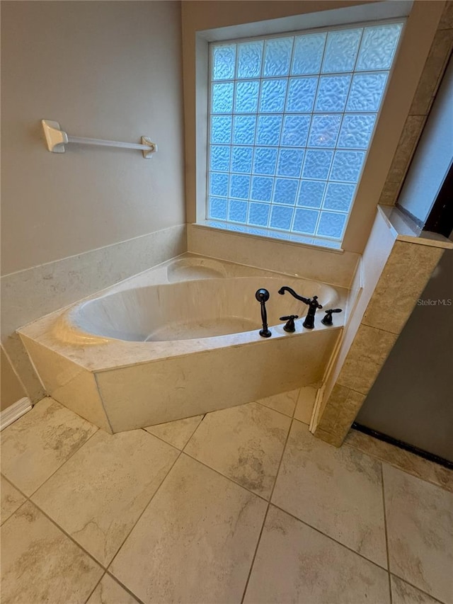 bathroom with a bathtub and tile patterned flooring