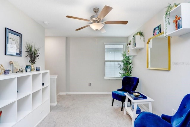 living area featuring ceiling fan and light colored carpet