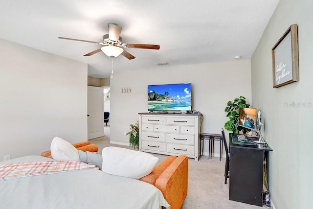 bedroom with ceiling fan and light carpet