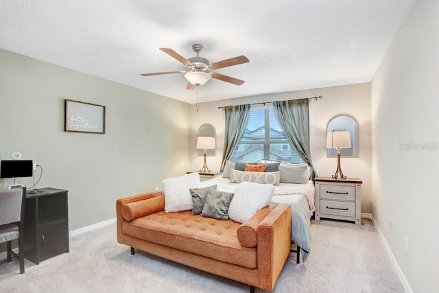 bedroom featuring ceiling fan and light carpet