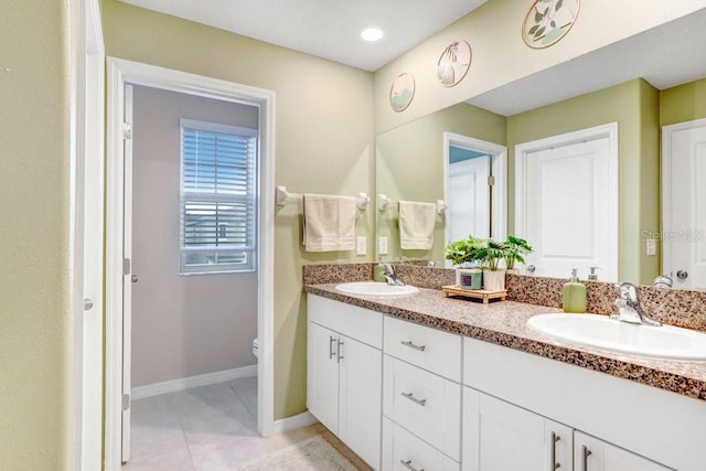 bathroom featuring tile patterned floors, vanity, and toilet