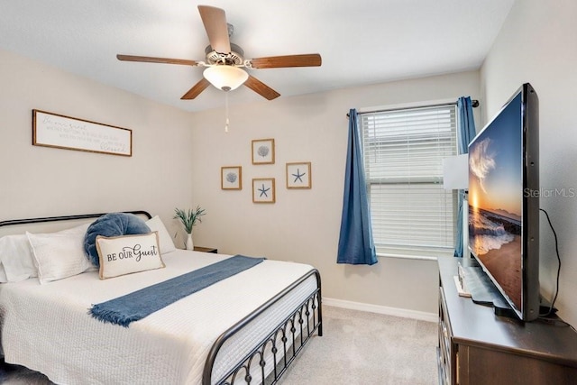 bedroom featuring ceiling fan and light carpet