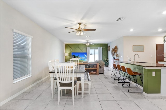 tiled dining room featuring sink