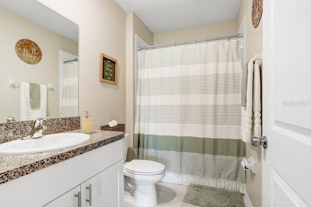 bathroom featuring toilet, vanity, and tile patterned floors