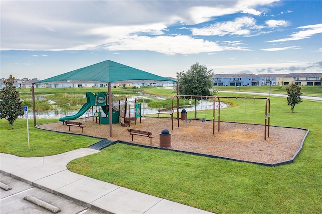 view of play area featuring a lawn and a water view