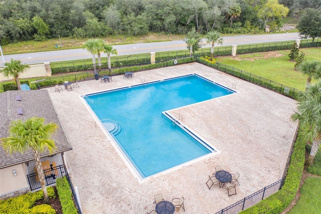 view of swimming pool with a lawn and a patio area