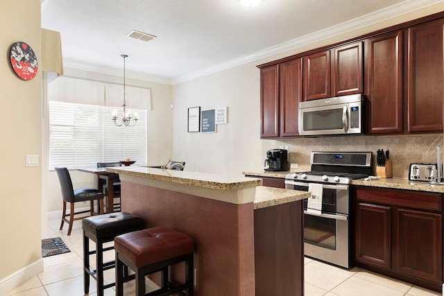 kitchen with ornamental molding, a notable chandelier, a center island, and stainless steel appliances