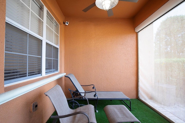 sunroom / solarium featuring ceiling fan