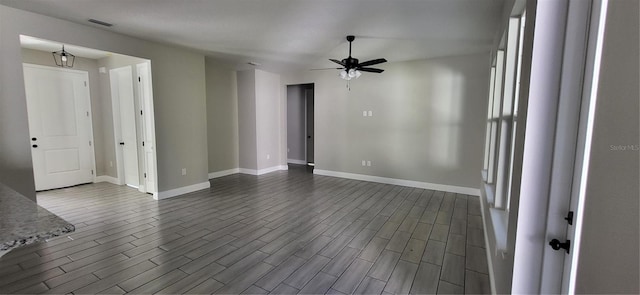 empty room with dark wood-type flooring and ceiling fan