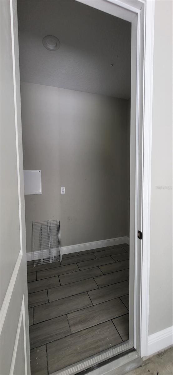 interior space featuring baseboards and wood finished floors