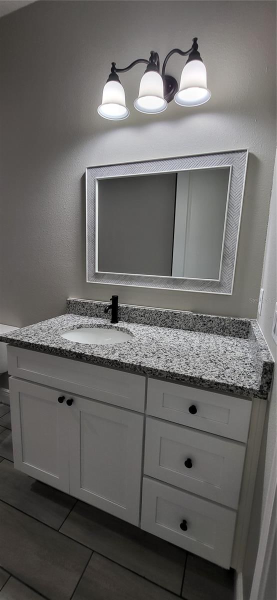 bathroom with vanity and tile patterned floors