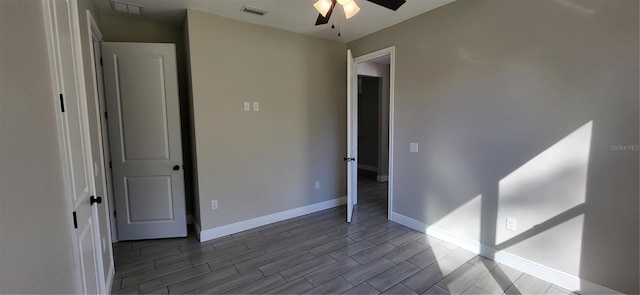 unfurnished bedroom with visible vents, baseboards, wood finished floors, and a ceiling fan