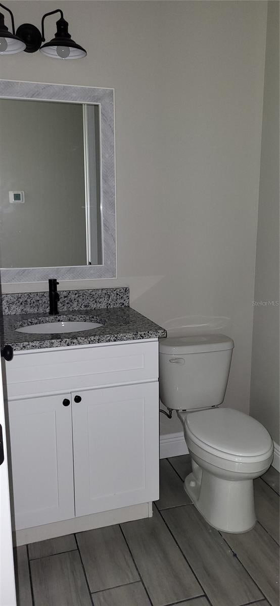 bathroom with toilet and vanity