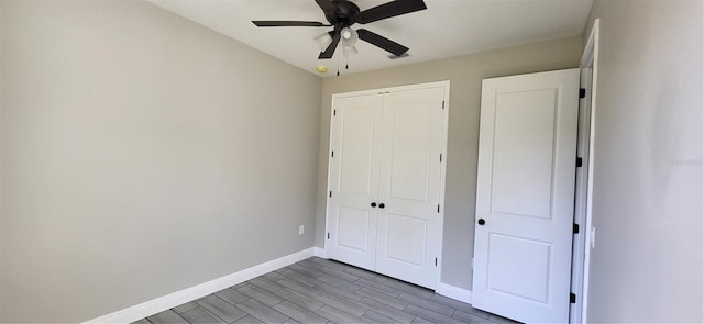 unfurnished bedroom with a closet, a ceiling fan, baseboards, and wood tiled floor