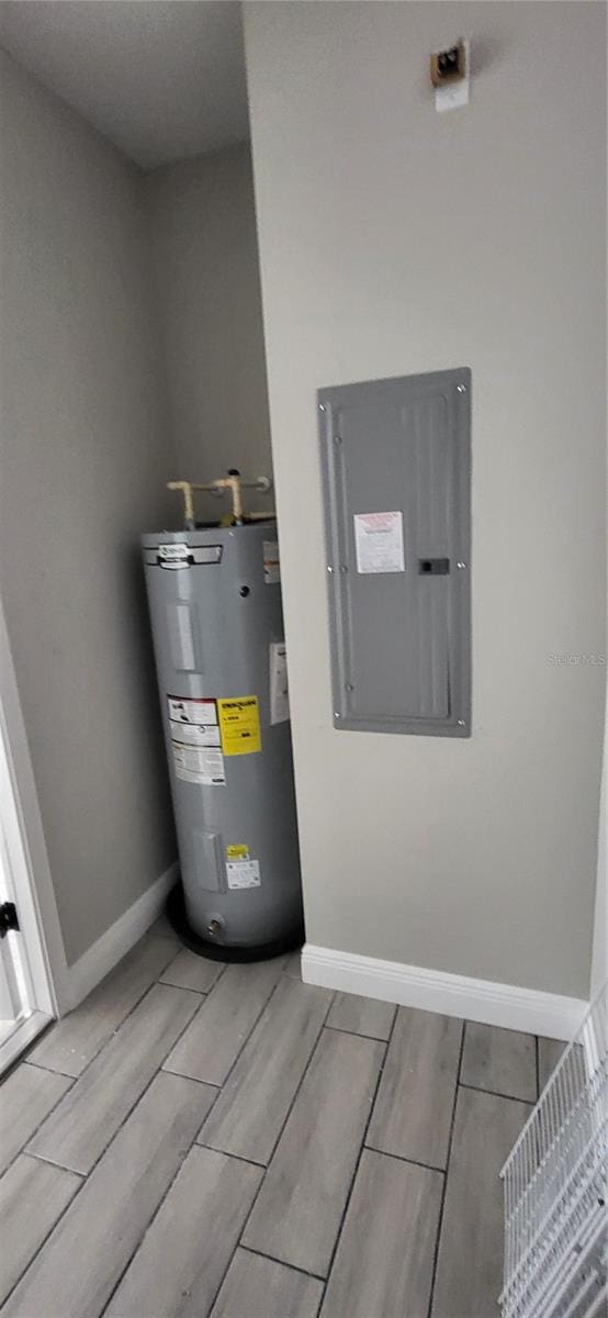 utility room featuring water heater and electric panel