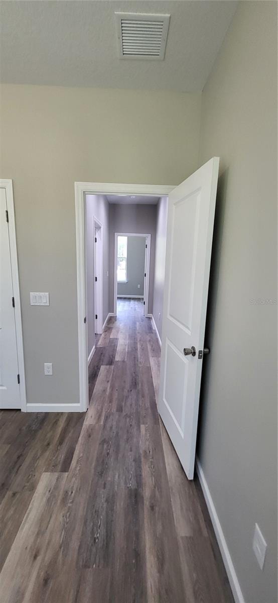 hall with dark hardwood / wood-style floors