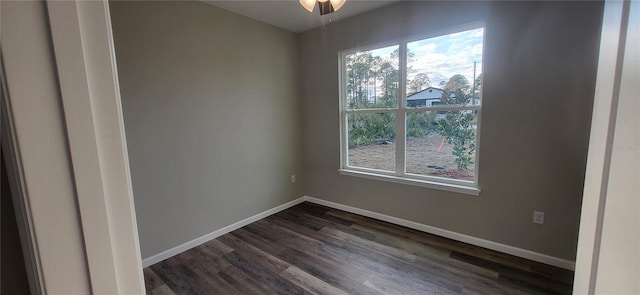 empty room with ceiling fan and dark wood-type flooring