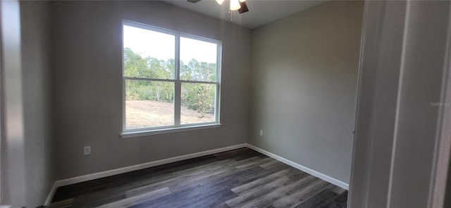 empty room with ceiling fan and dark hardwood / wood-style floors